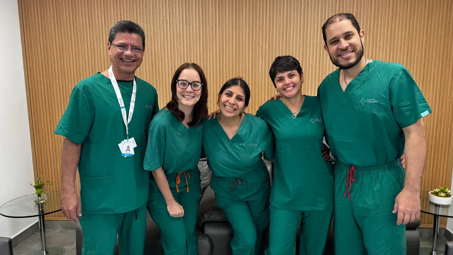 Five Hospital Paitilla professionals in green scrubs, smiling together after a filming session